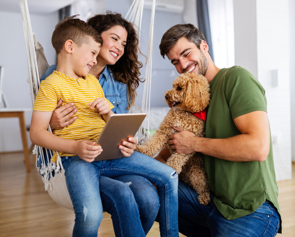 Happy,Family,With,Modern,Devices,And,Dog,Having,Fun,,Playing